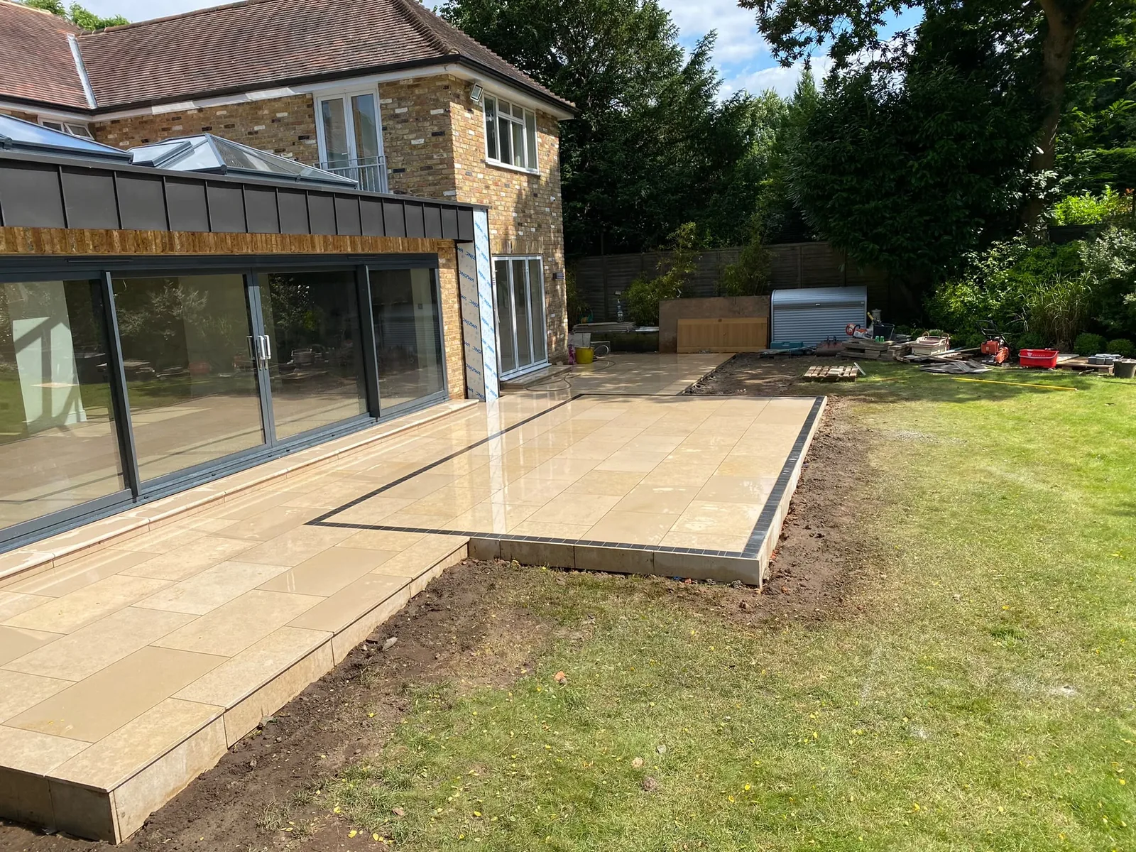 Stone patio beside a modern house